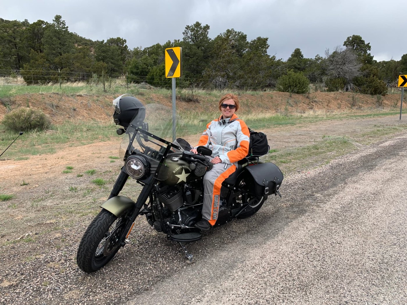 Christin with a Harley-Davidson motorcycle on the open road