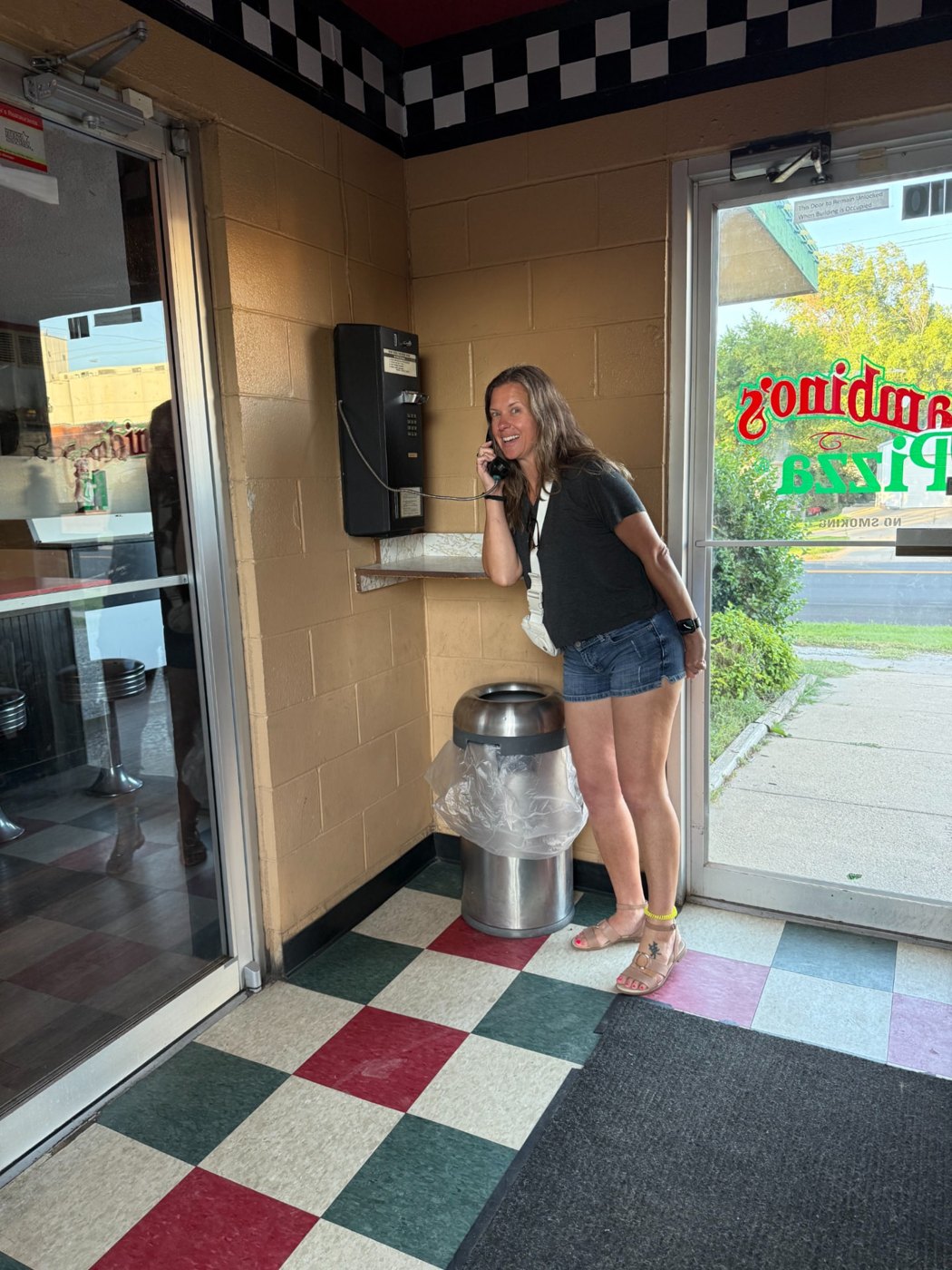 Christin using a vintage black payphone